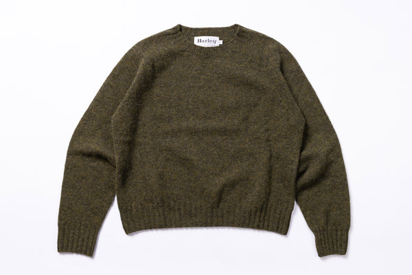 Green sweater with 'Harley' label on a white background