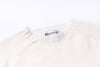 Close-up of a white sweater with a 'Harley' label on a white background