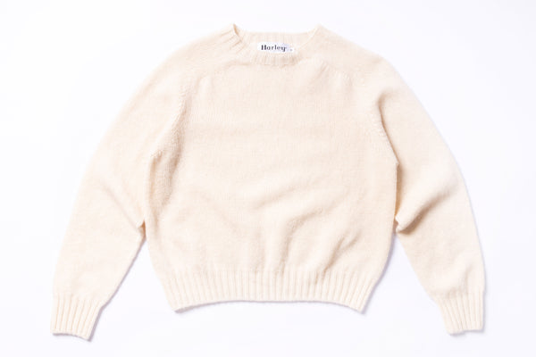 Beige sweater with  branding on a white background
