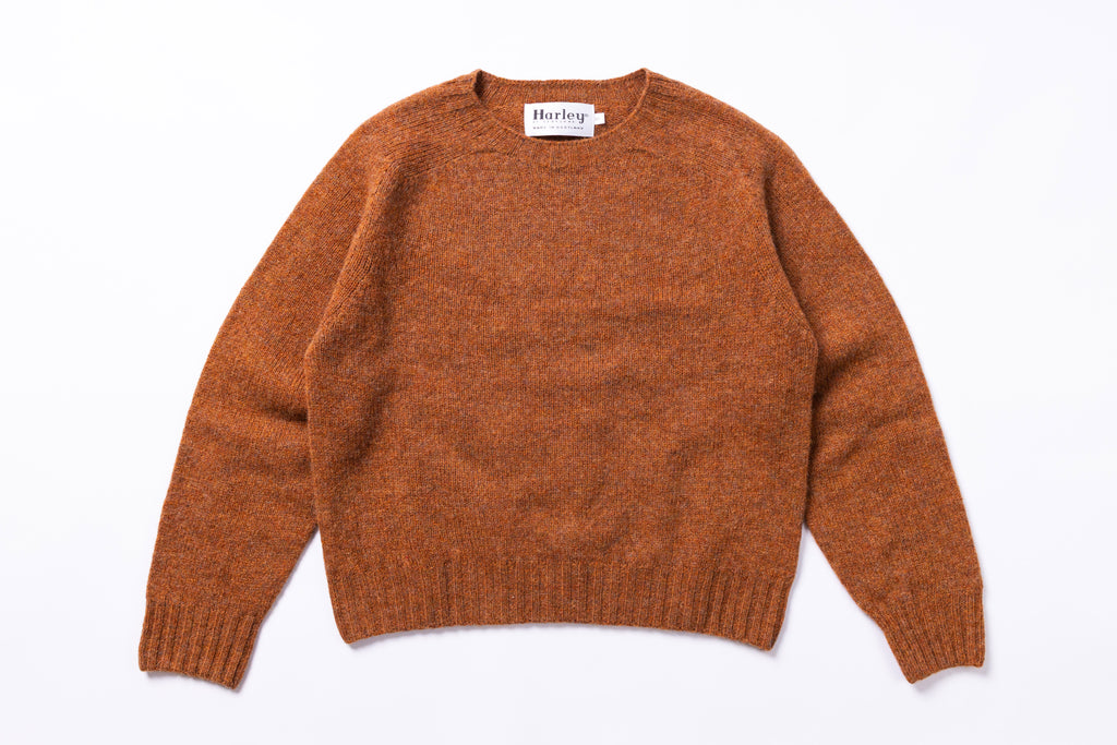 Brown sweater with 'Harley' label on a white background