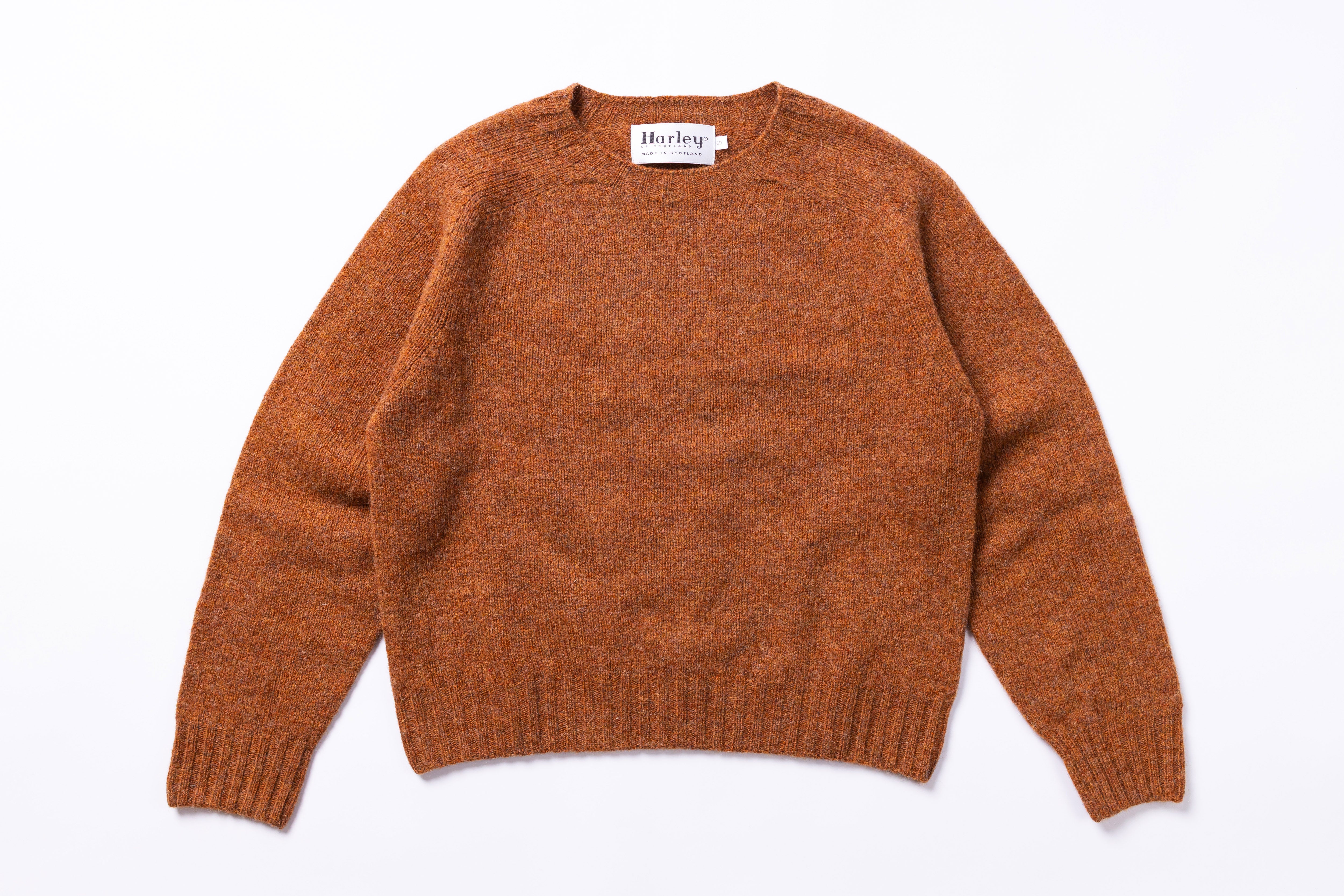 Brown sweater with 'Harley' label on a white background