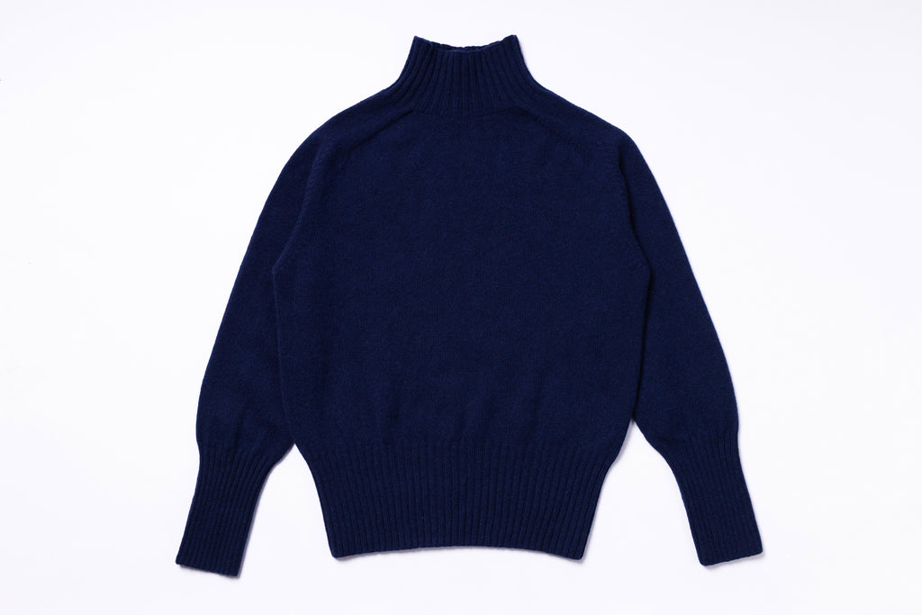 Navy blue turtleneck sweater on a white background