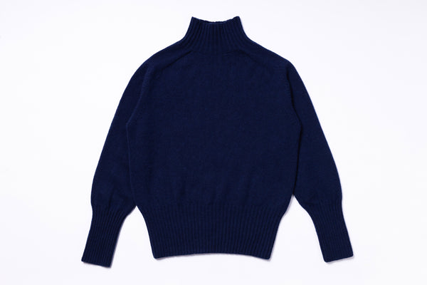 Navy blue turtleneck sweater on a white background