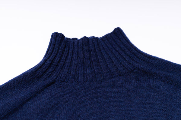 Close-up of a blue ribbed sweater collar on a white background