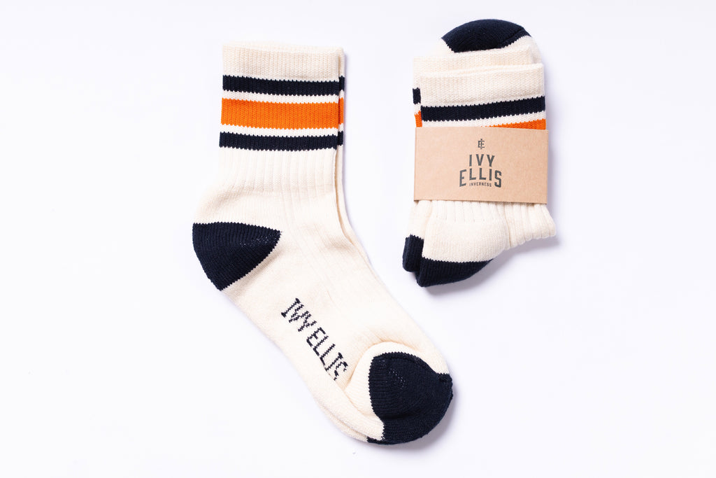 Pair of socks with striped pattern and visible brand label on a white background