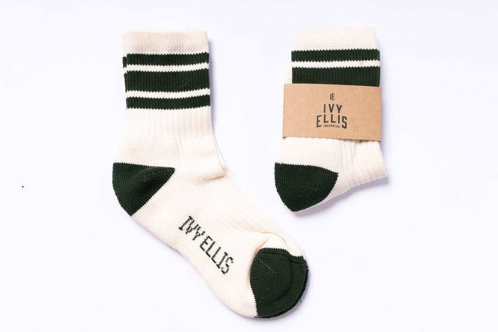 Pair of white socks with green stripes and cuffs, featuring 'Ivy Ellis' branding, on a white background.