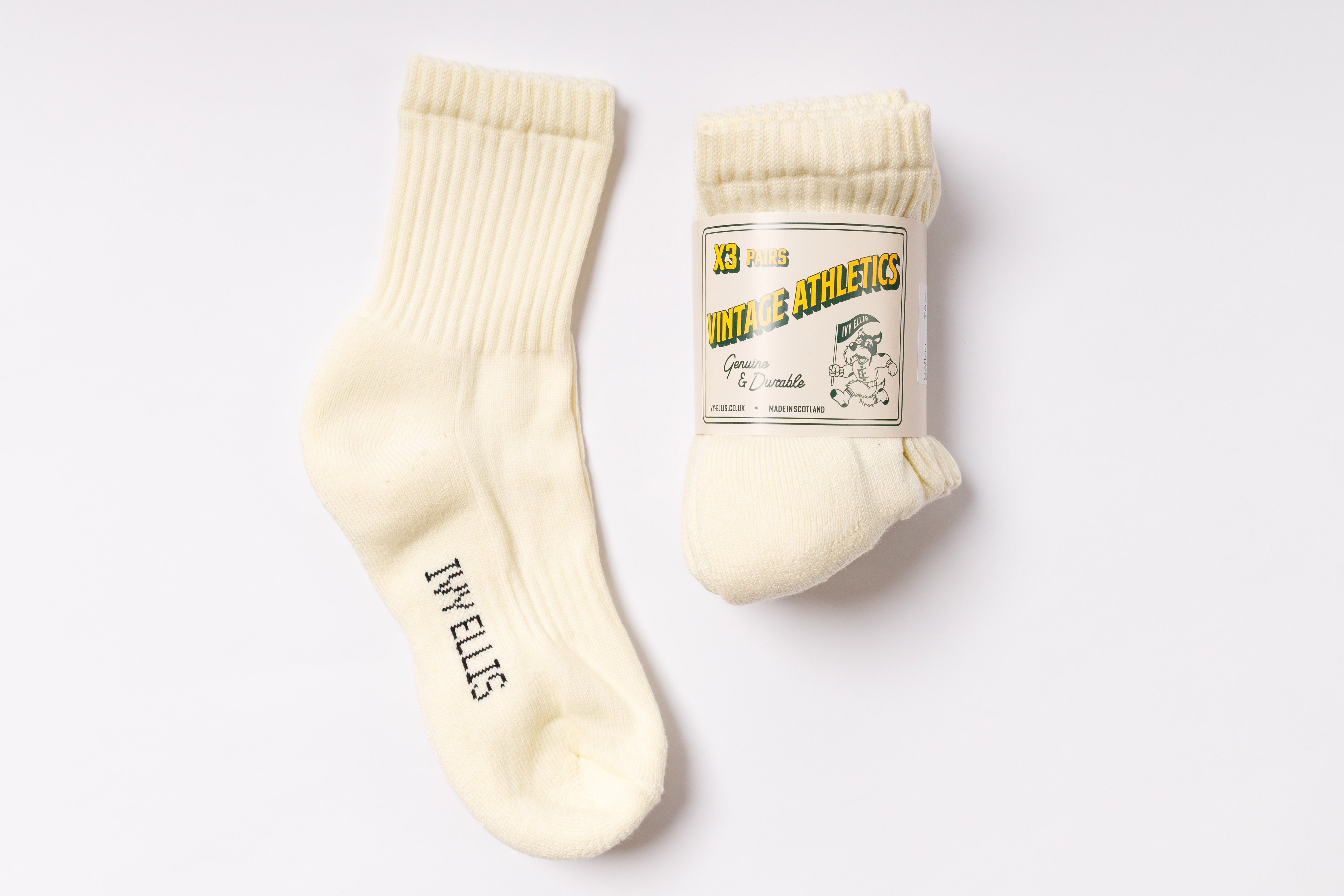 Pair of cream-colored socks with a label on a white background
