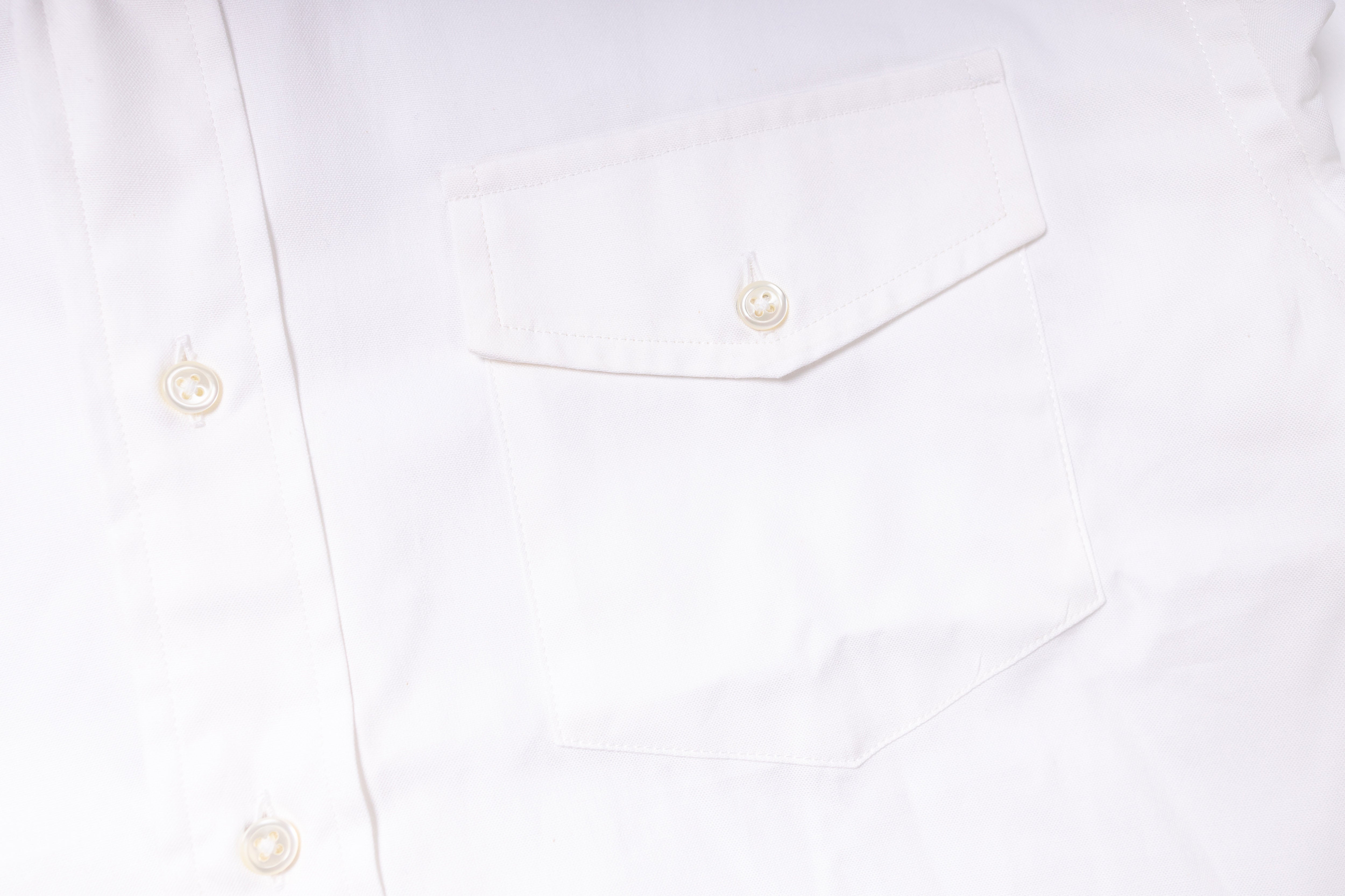 Close-up of a white shirt with buttons on a white background