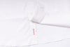 White shirt with a brand label on a white background