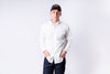 Person wearing a white shirt and dark pants with a cap on a white background