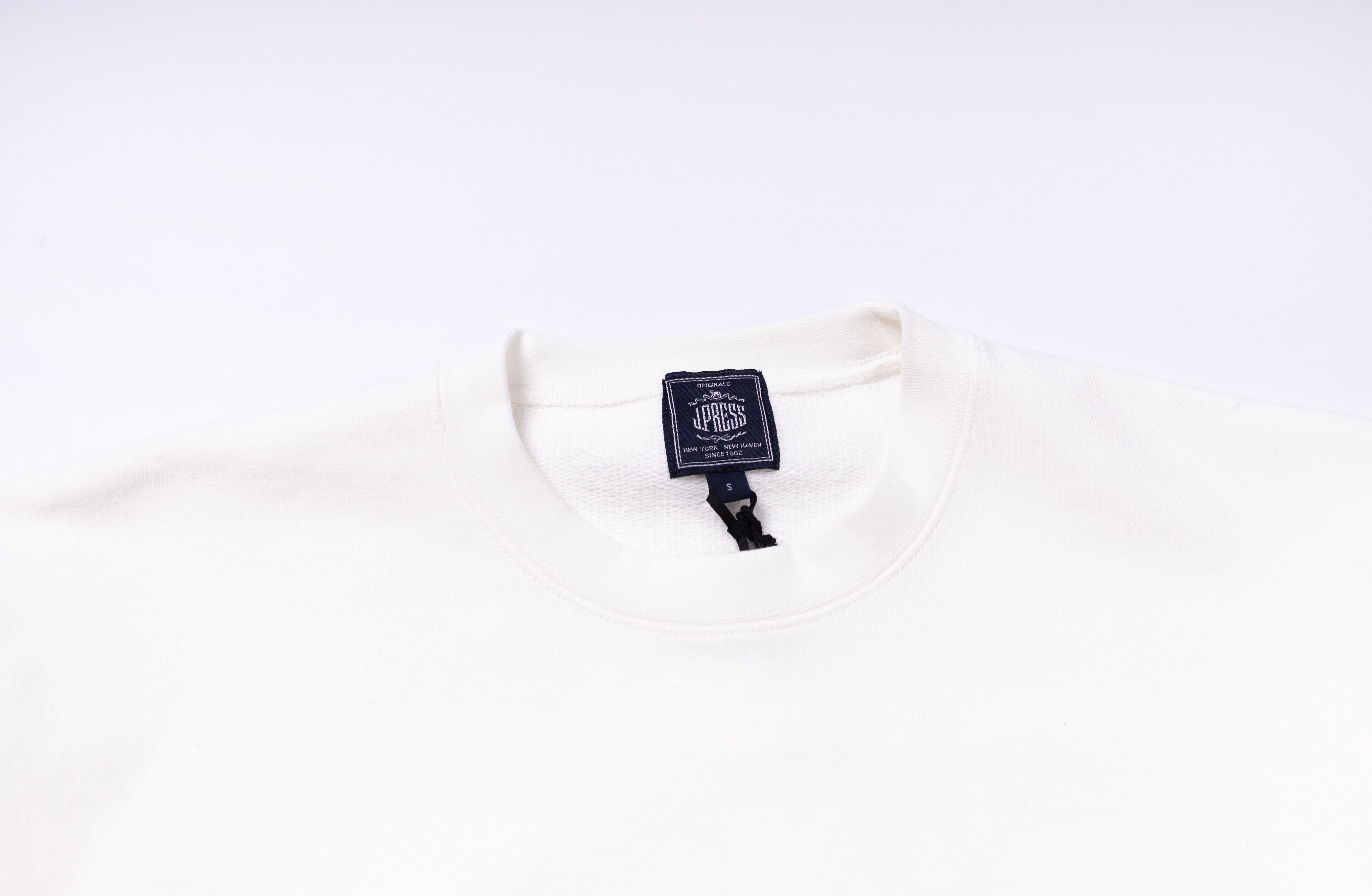 White shirt with a brand tag on a white background