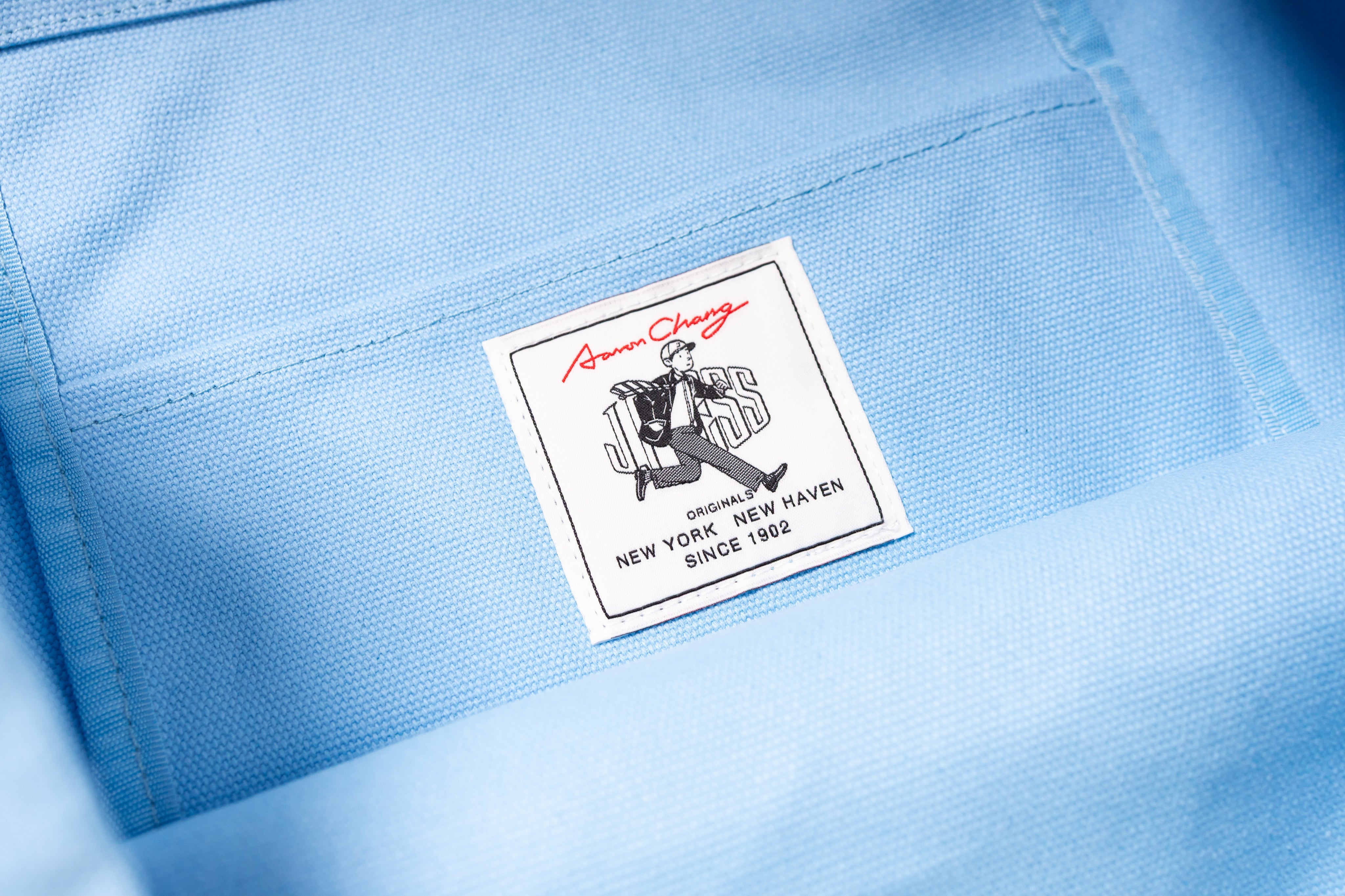 Close-up of a label on a light blue fabric background