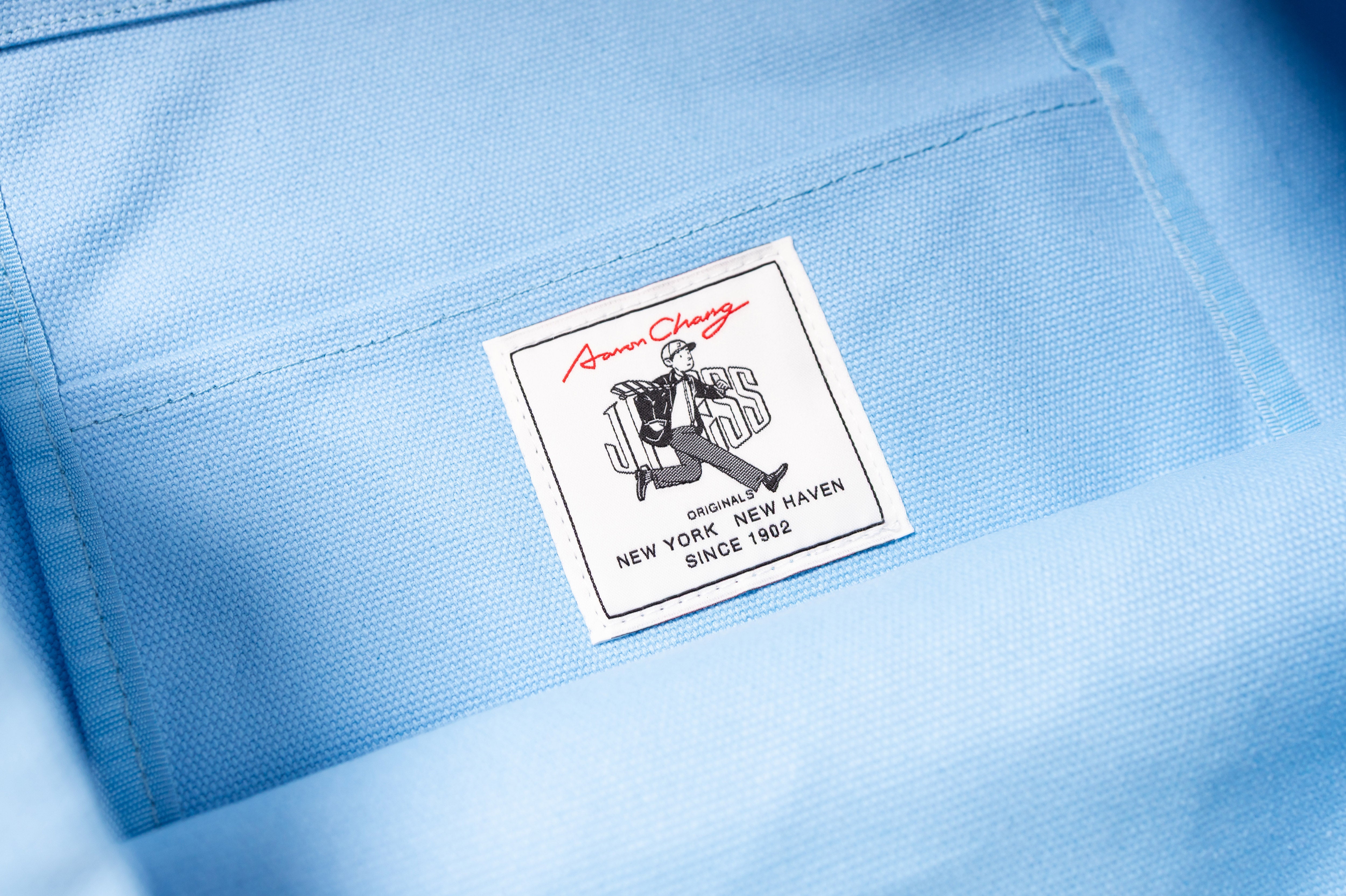 Close-up of a label on a light blue fabric background