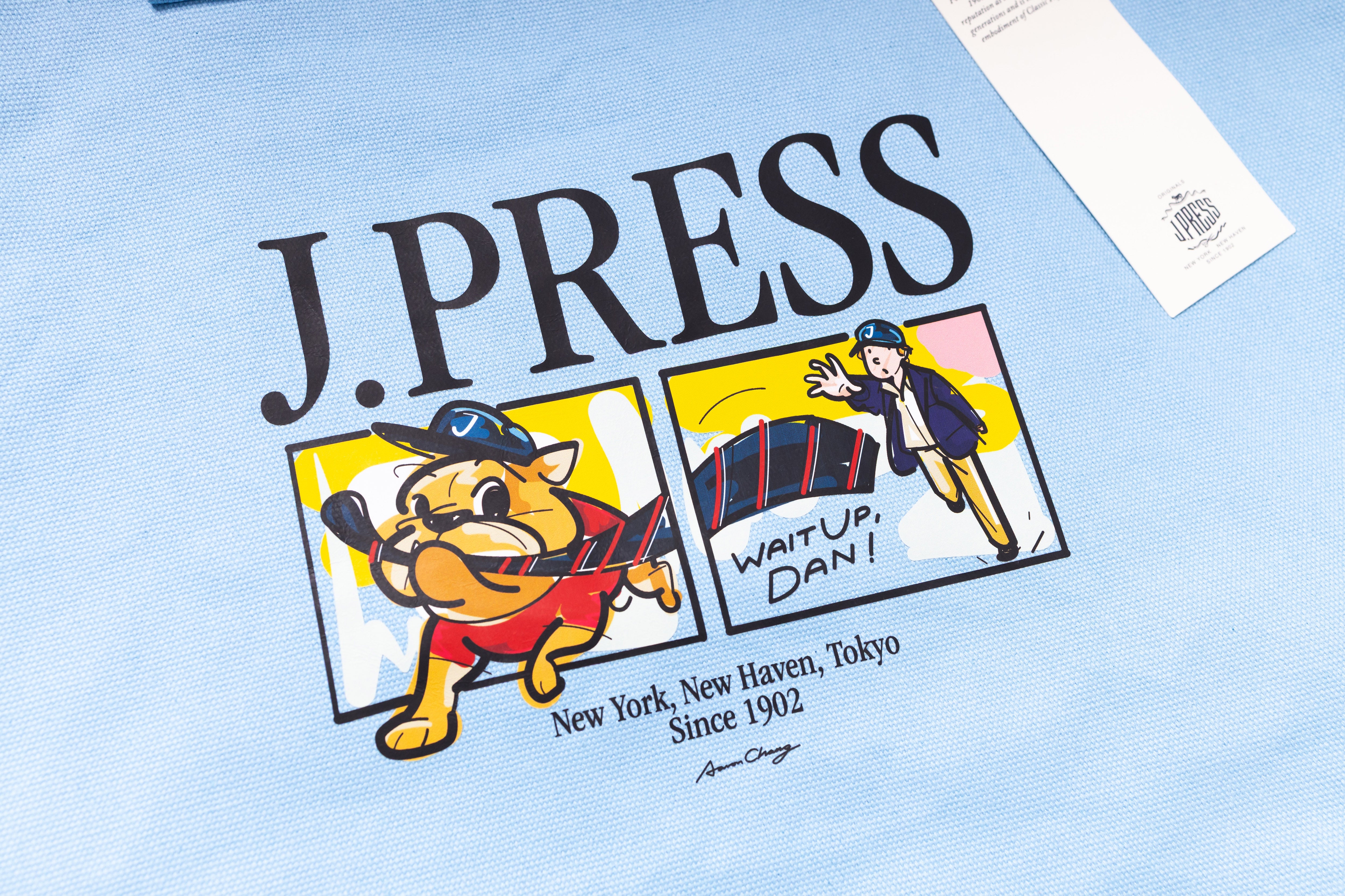 Light blue t-shirt with cartoon dog and text on a light blue background