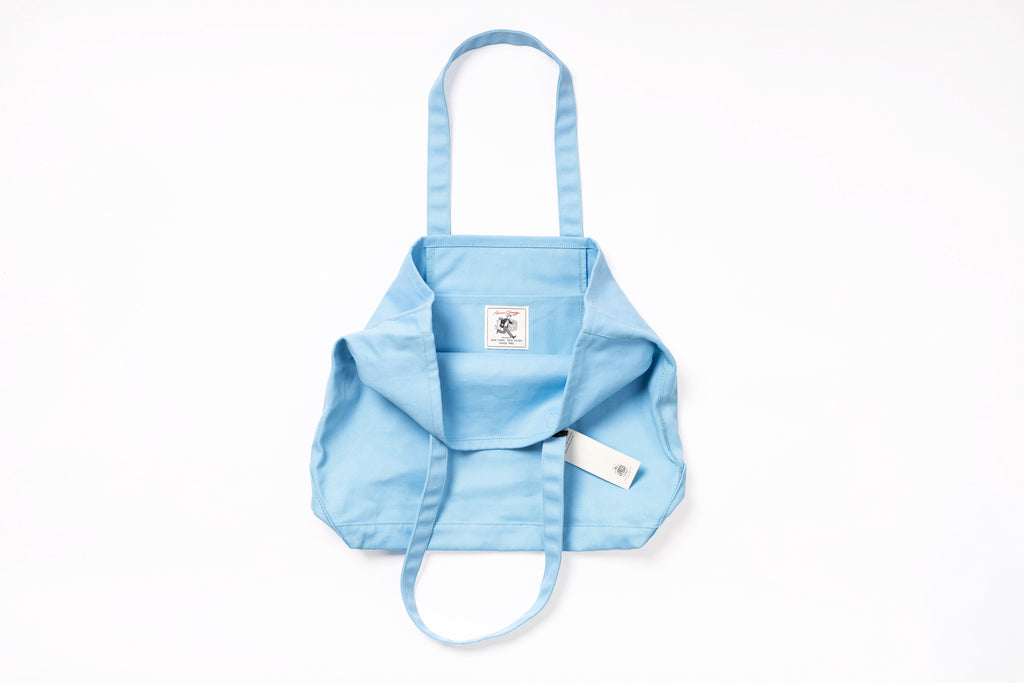 Light blue baby carrier with straps on a white background