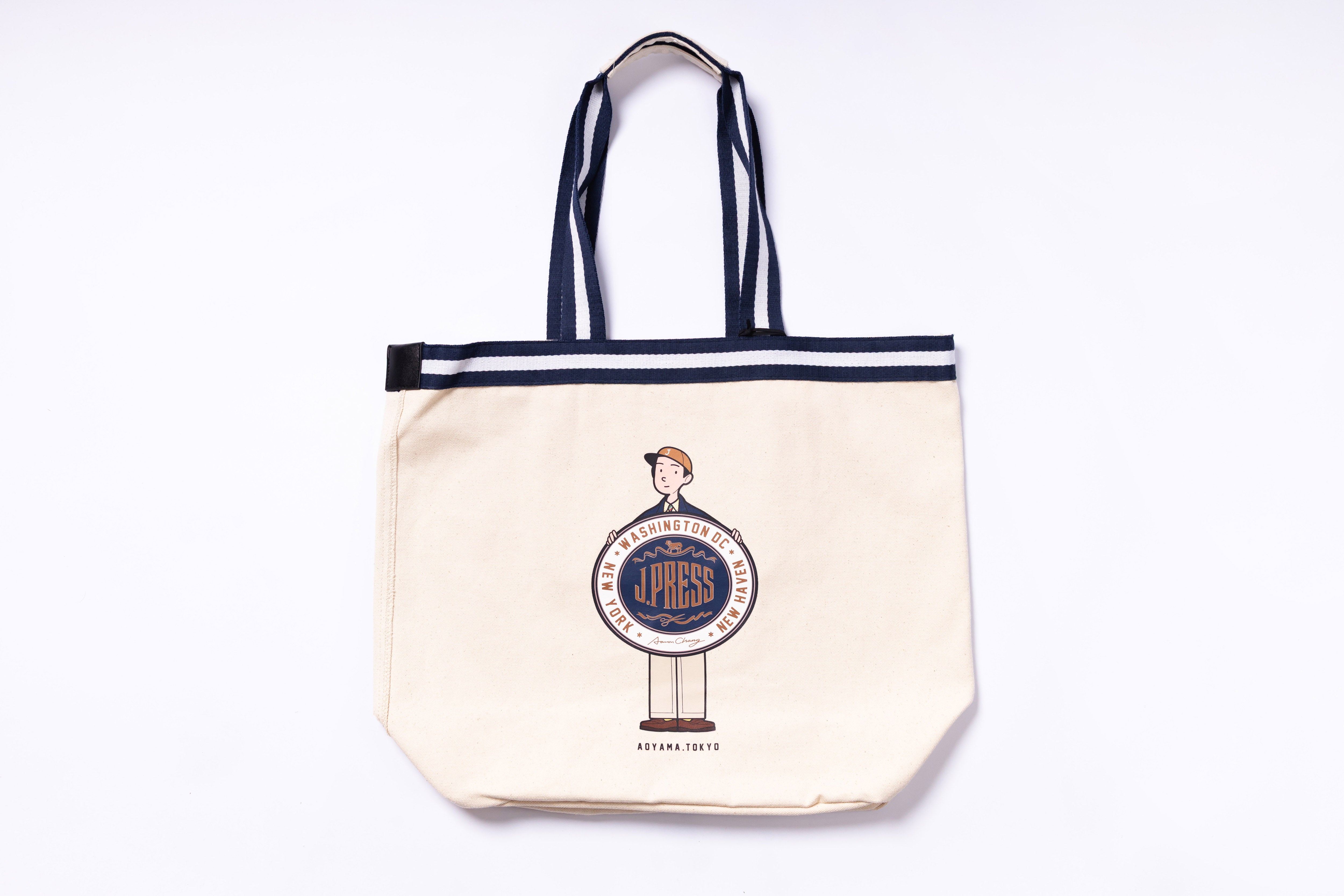 Beige tote bag with black straps featuring a logo on a white background