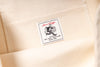 Close-up of a label on a beige fabric background