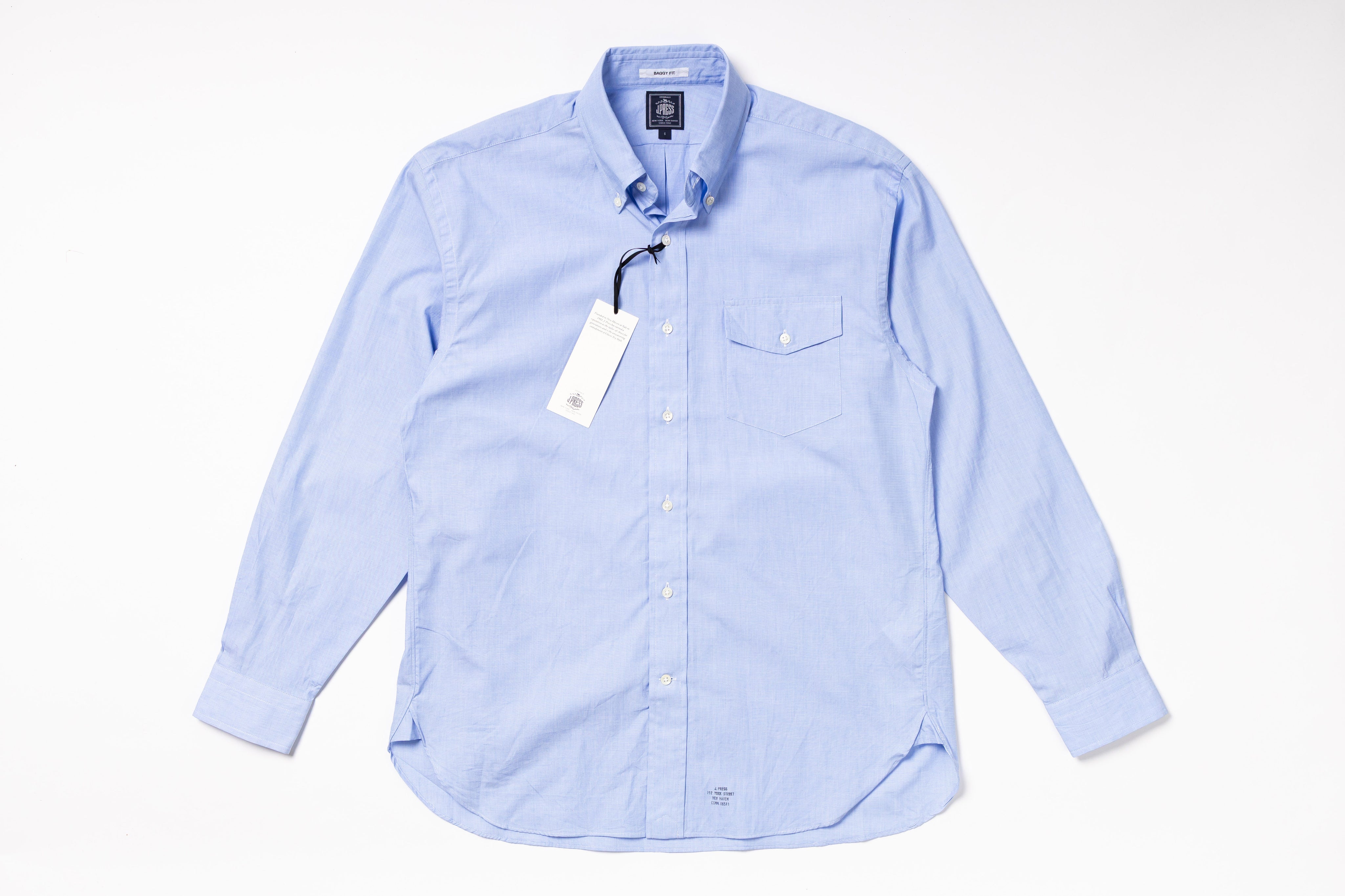 Light blue checkered shirt with a tag on a white background