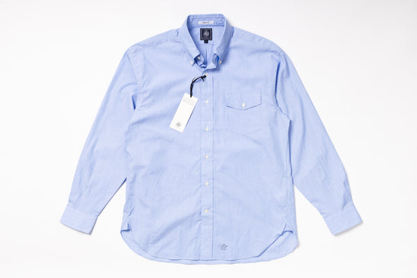 Light blue checkered shirt with a tag on a white background