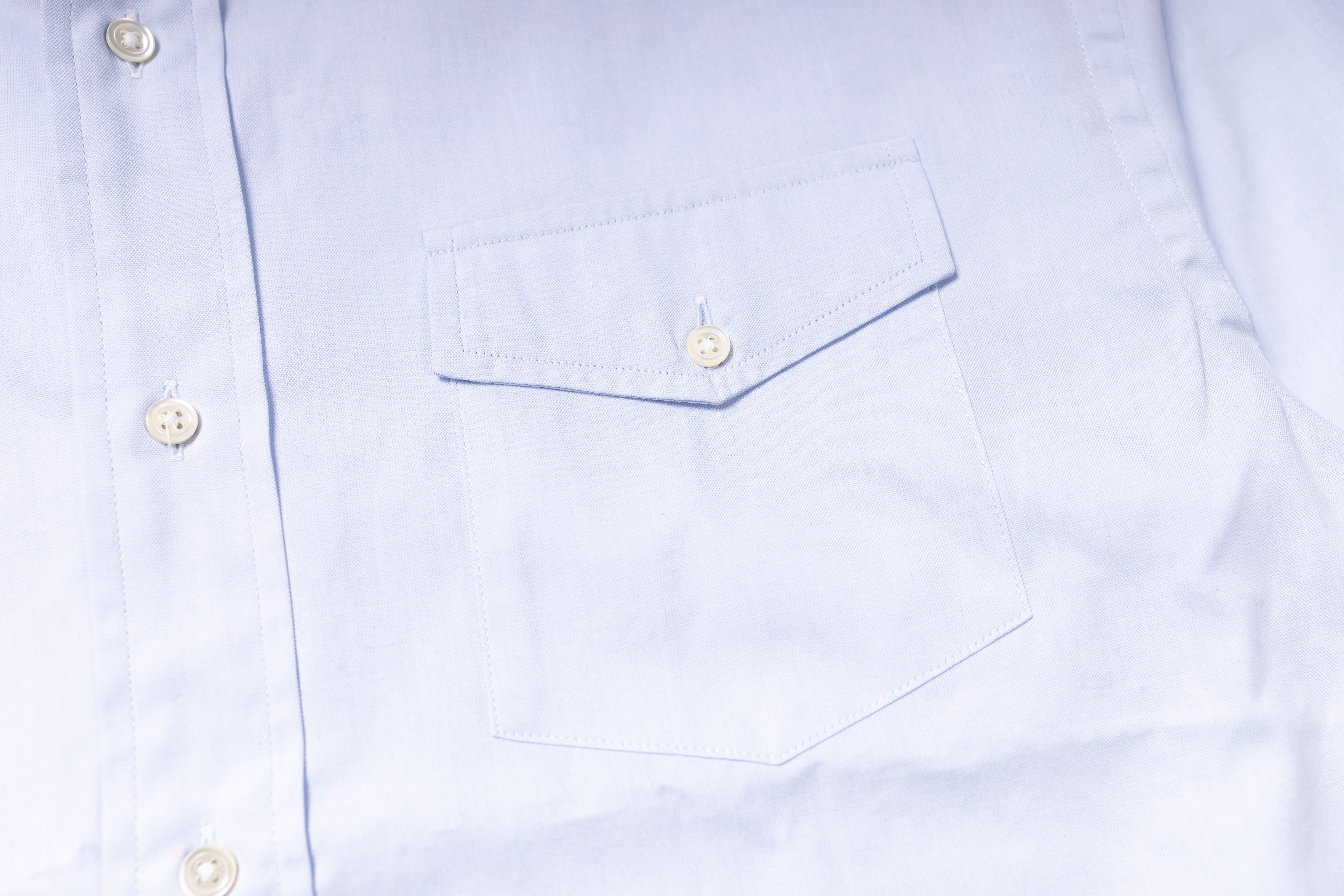 Close-up of a light blue shirt with button details
