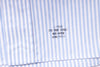 Close-up of a blue and white striped fabric with a brand label.