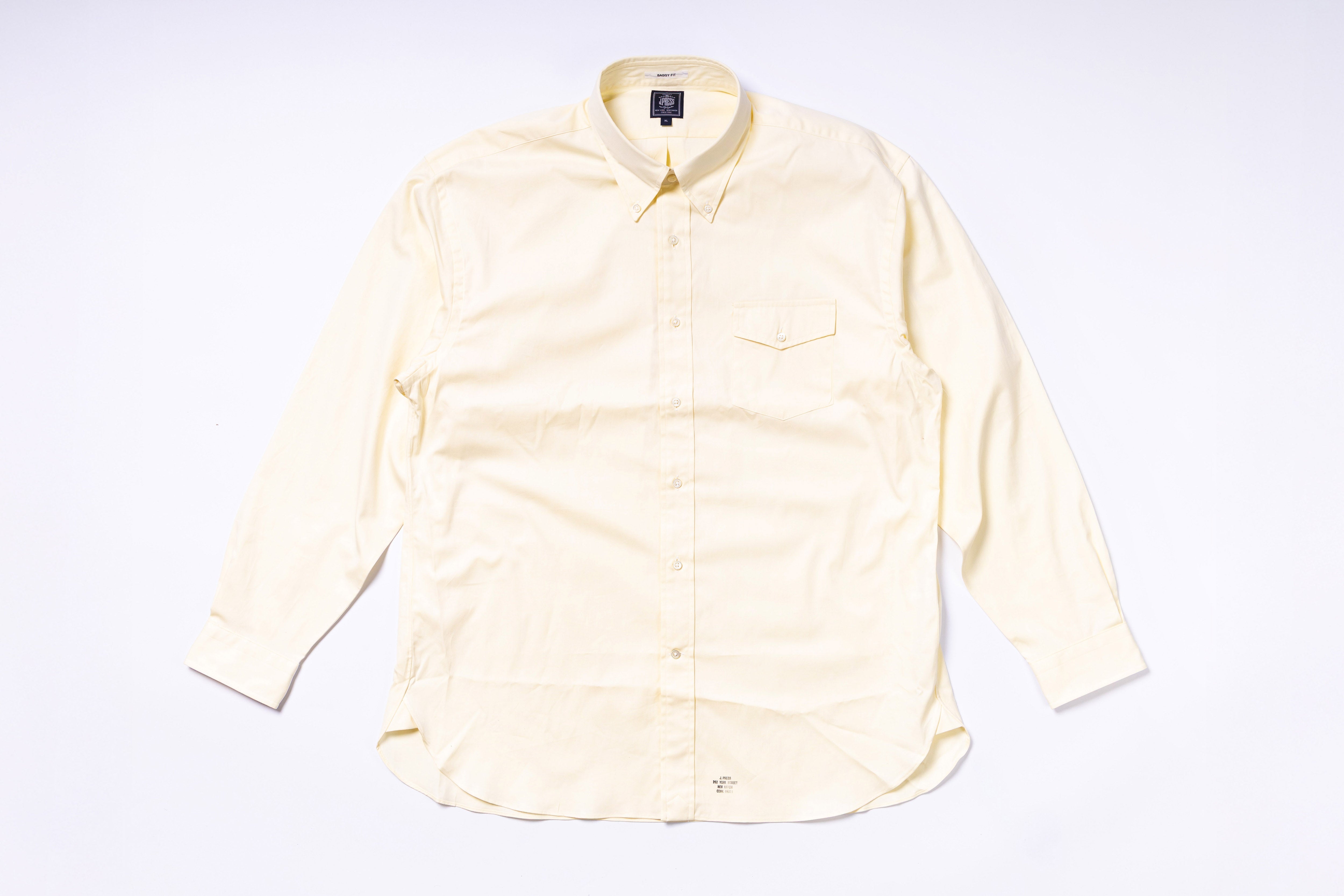 Light yellow button-up shirt on a white background