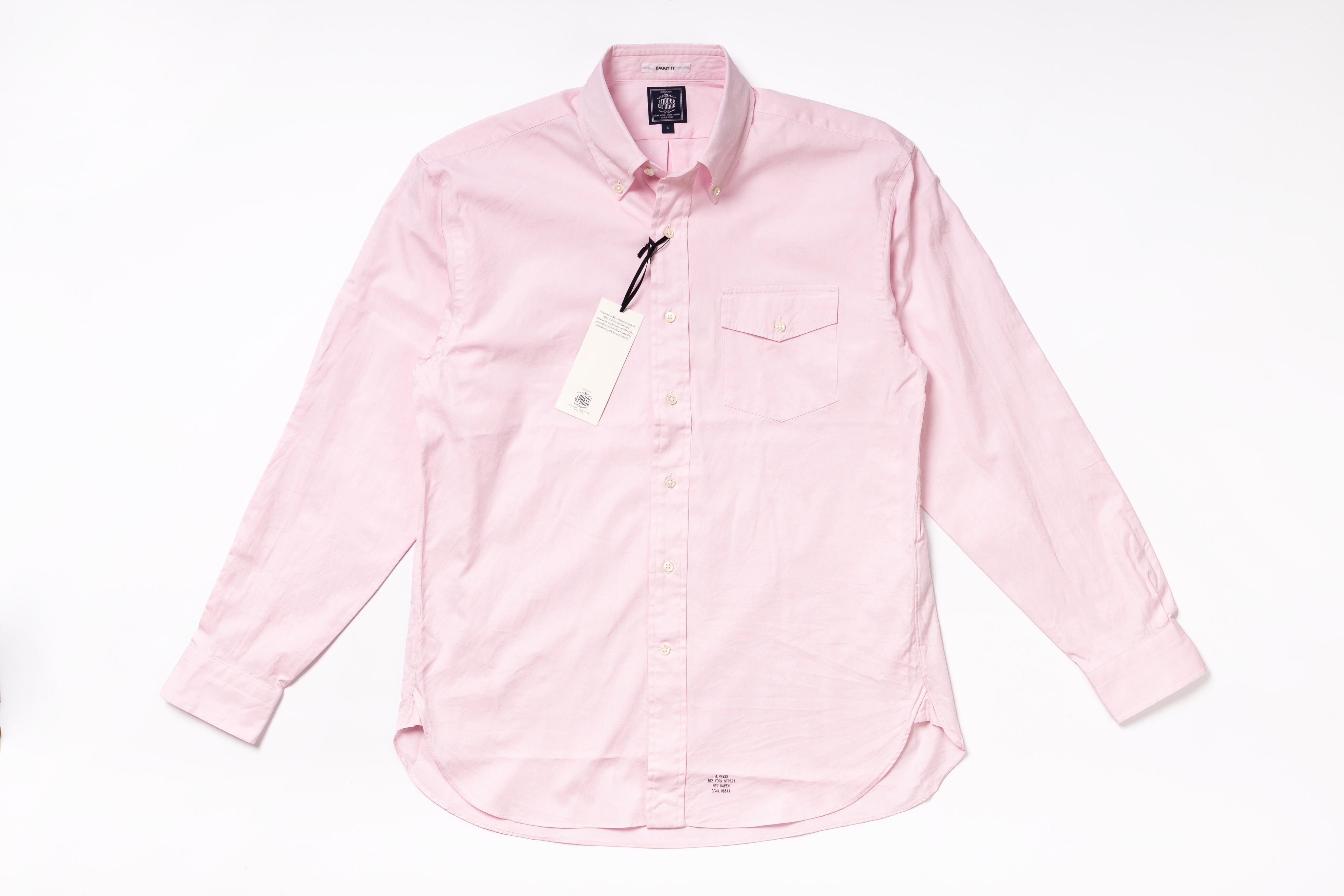 Pink shirt with a tag on a white background