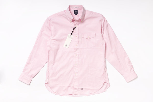 Pink shirt with a tag on a white background