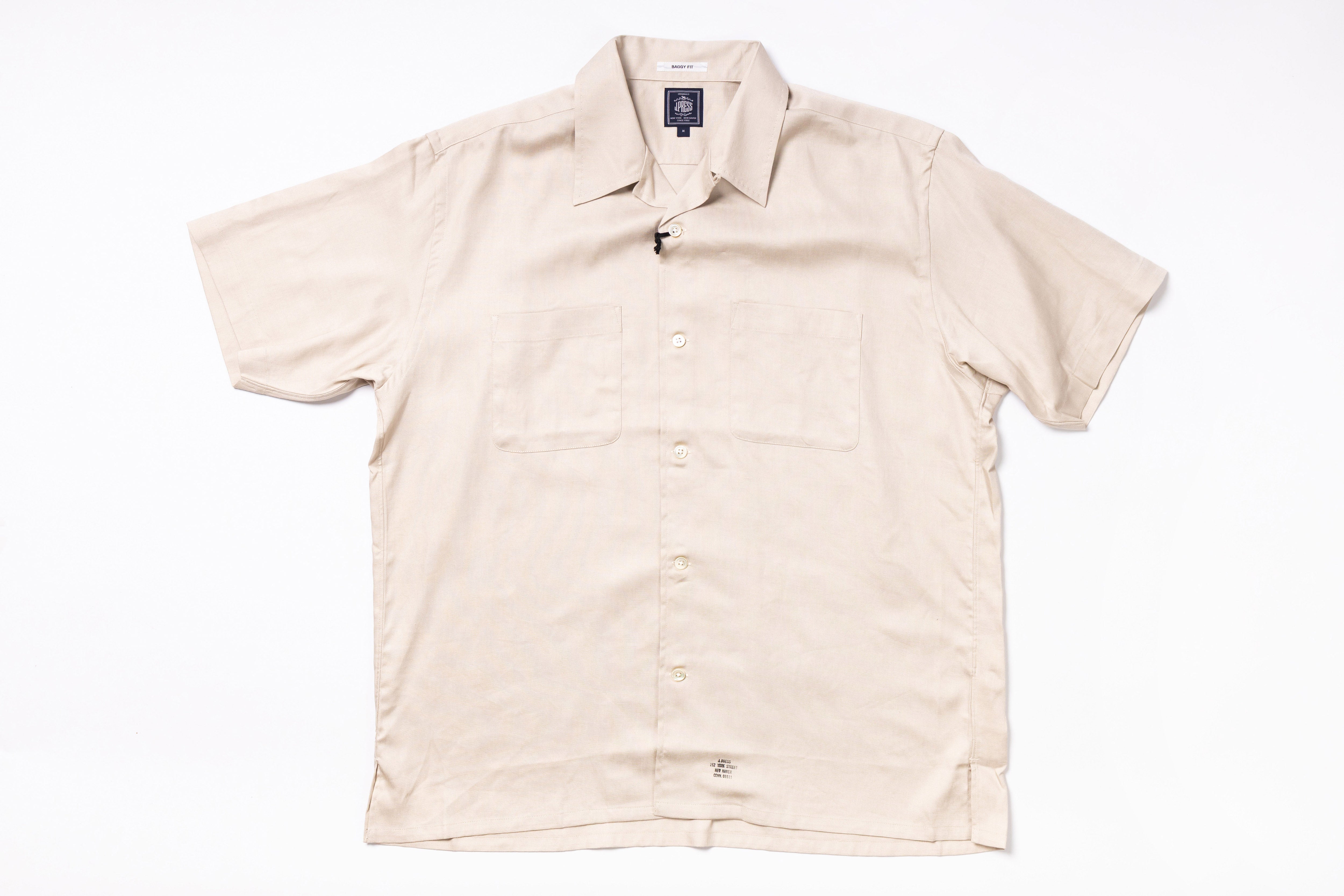 Beige short-sleeve shirt on a white background