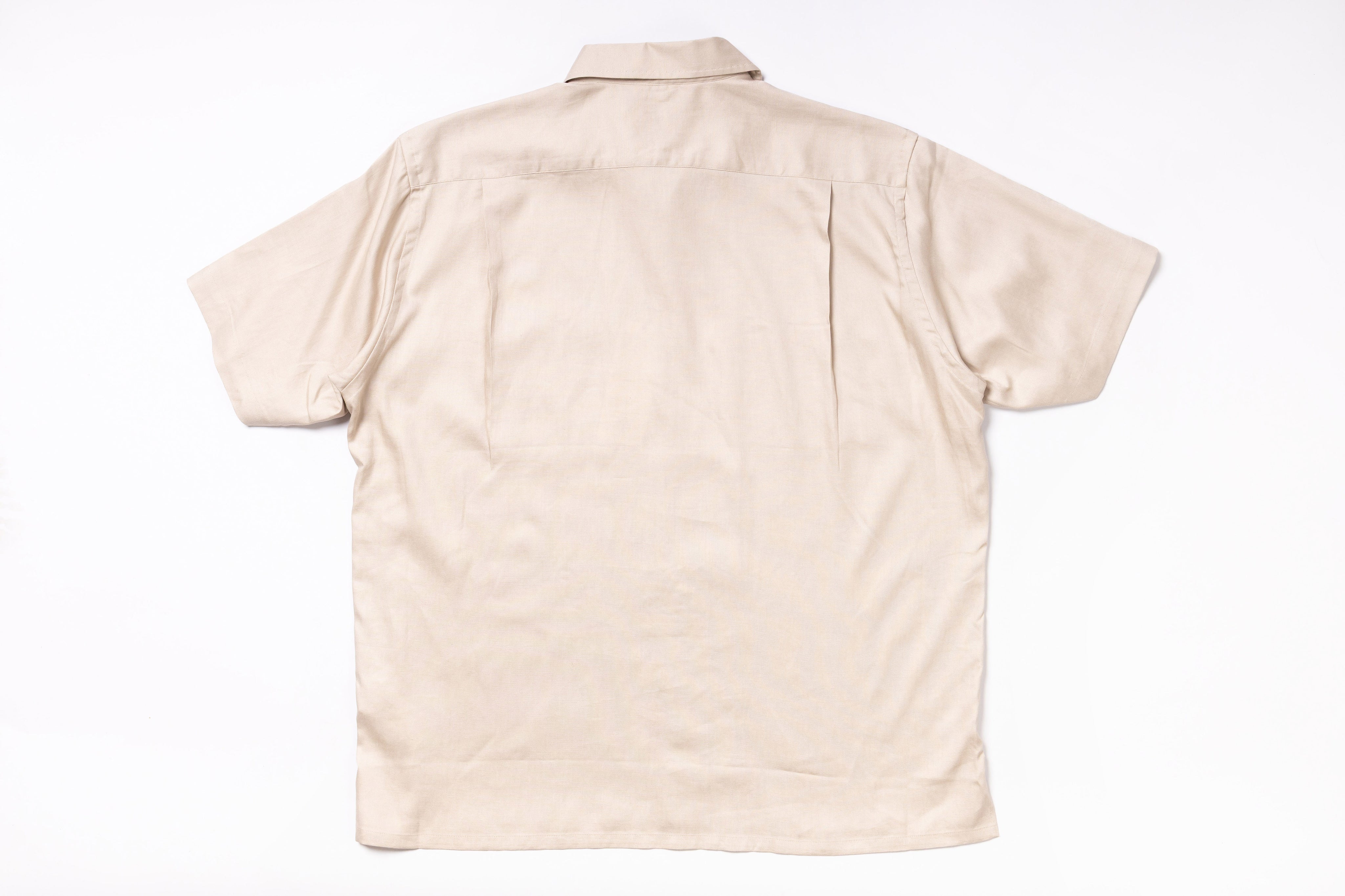 Beige short-sleeve shirt on a white background
