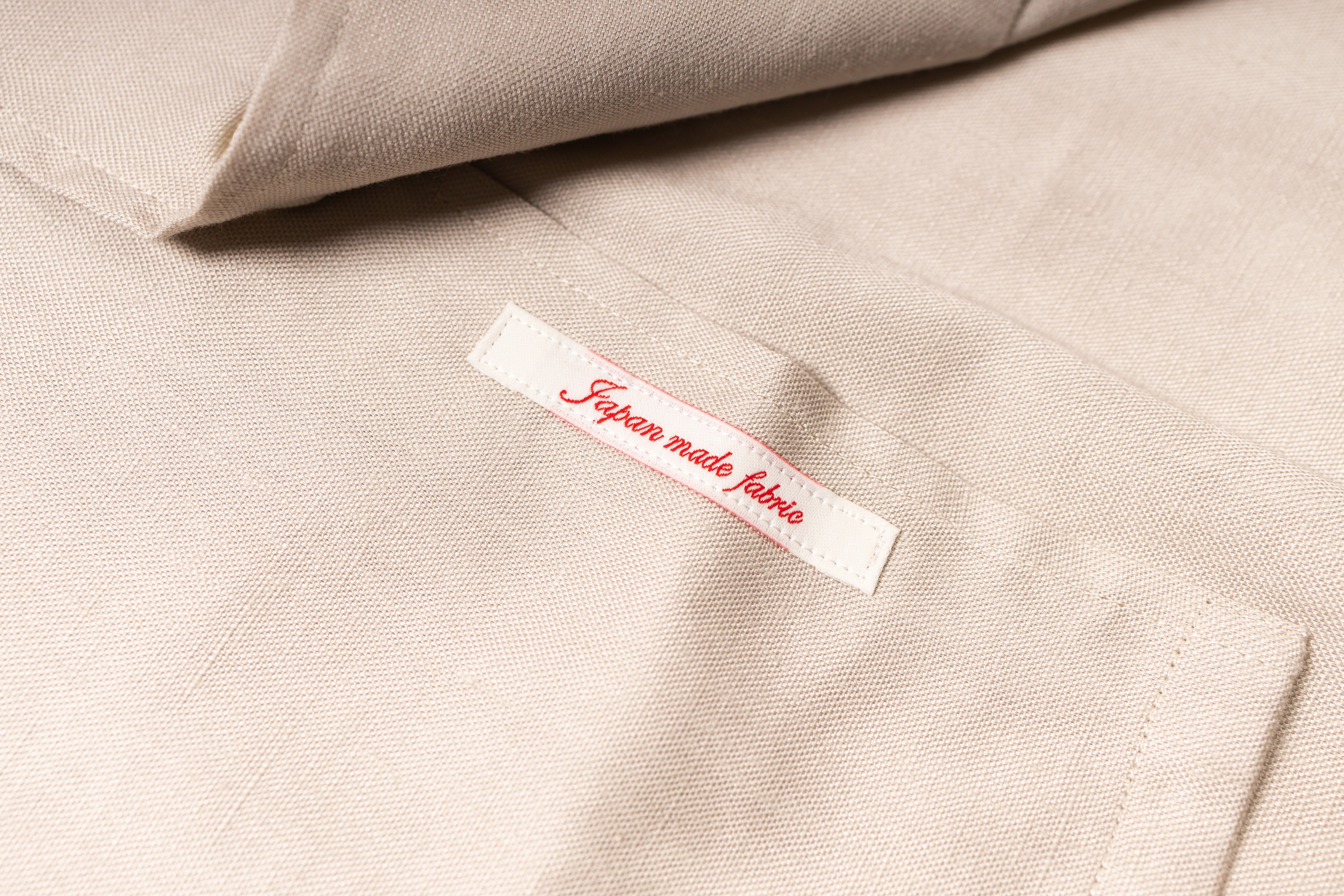 Close-up of beige fabric with a label
