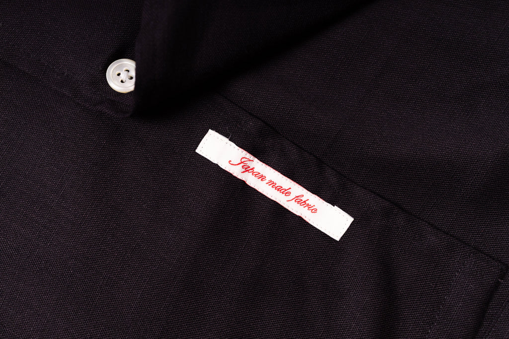 Close-up of a black fabric with a label indicating 'Japanese made fabric'.
