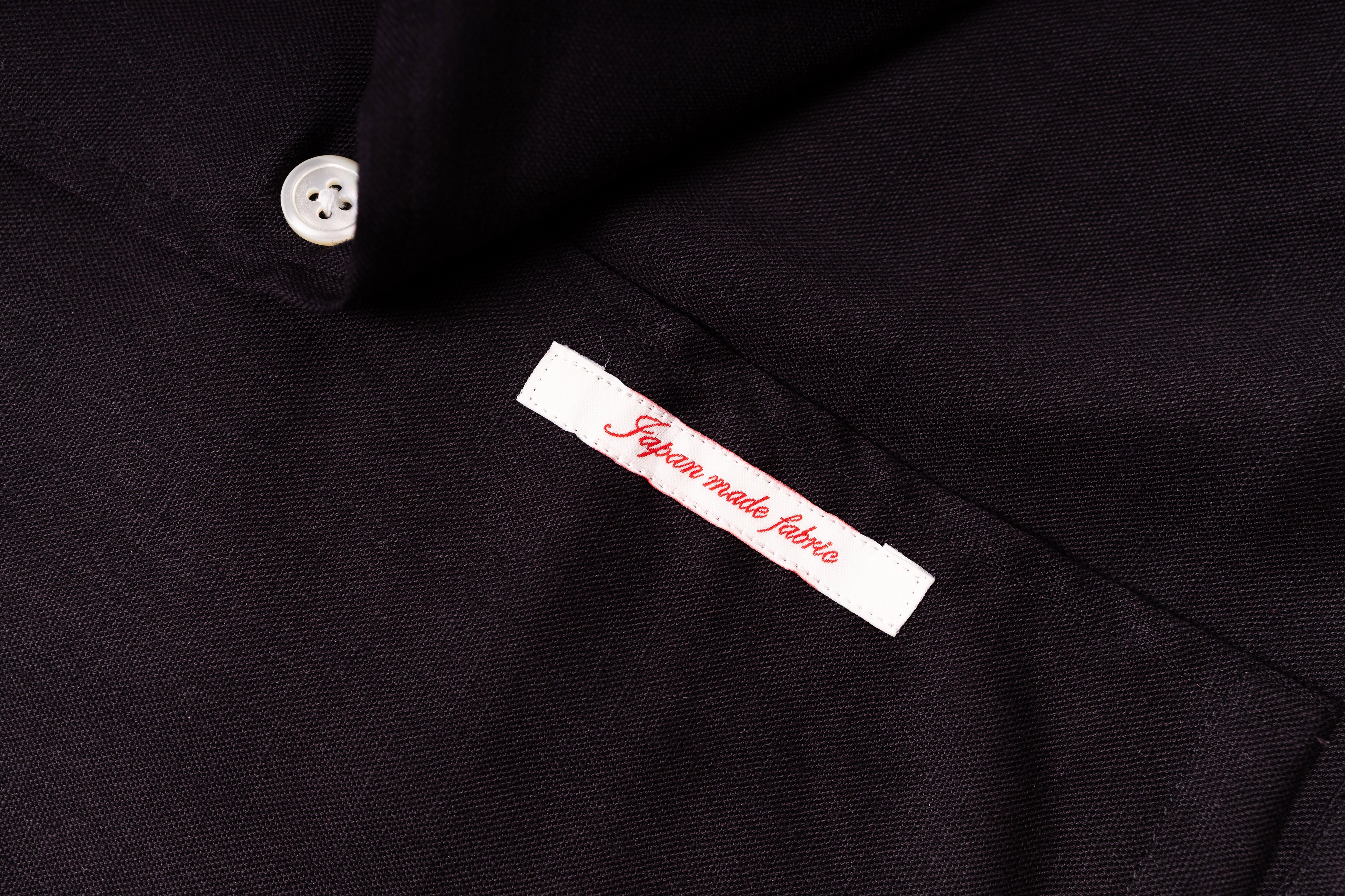 Close-up of a black fabric with a label indicating 'Japanese made fabric'.