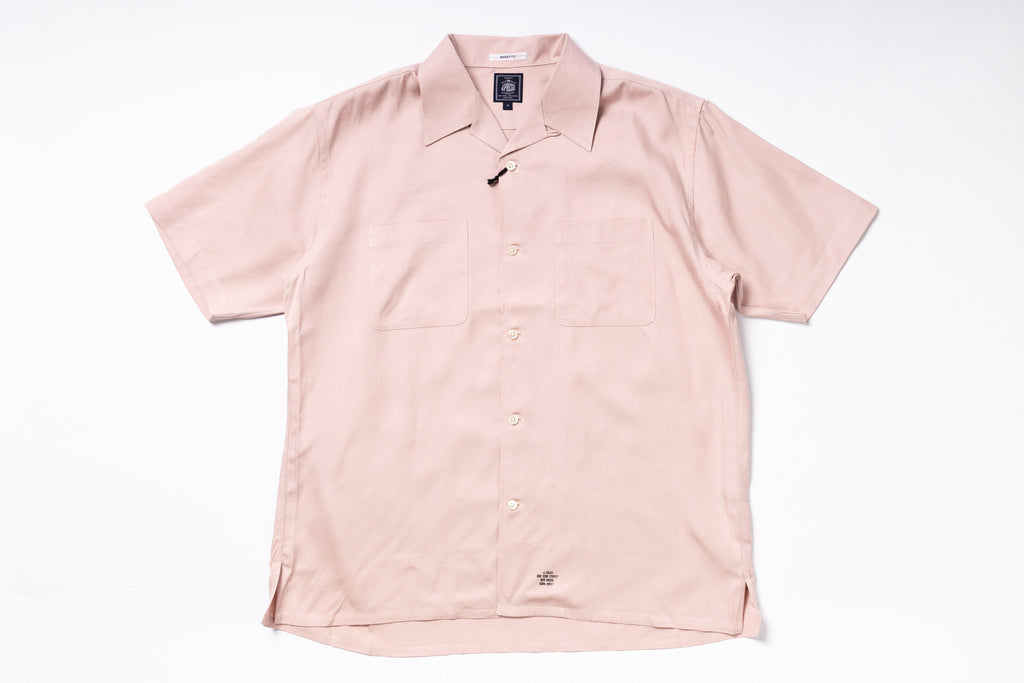 Pink short-sleeve shirt on a white background
