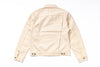 A light beige canvas utility jacket shown from the back, featuring a collar, long sleeves, and button details on the cuffs and hem, laid flat against a white background.