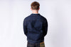 Person wearing a blue denim jacket on a white background