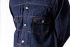 Close-up of a dark blue denim shirt with buttons on a white background