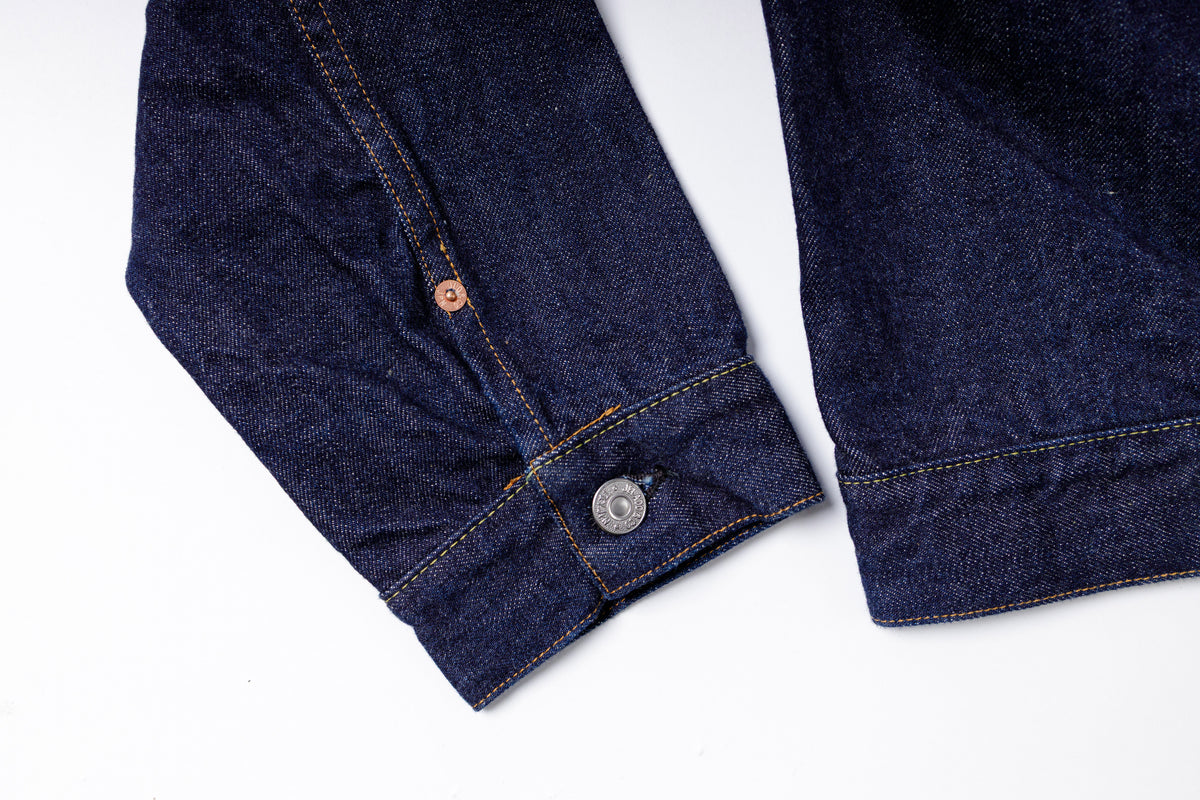 Close-up of a blue denim jacket on a white background