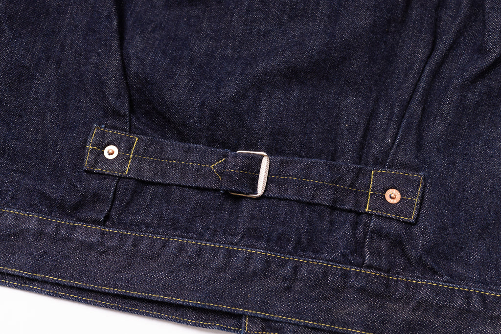 Close-up of a dark blue denim jacket with a buckle on a white background
