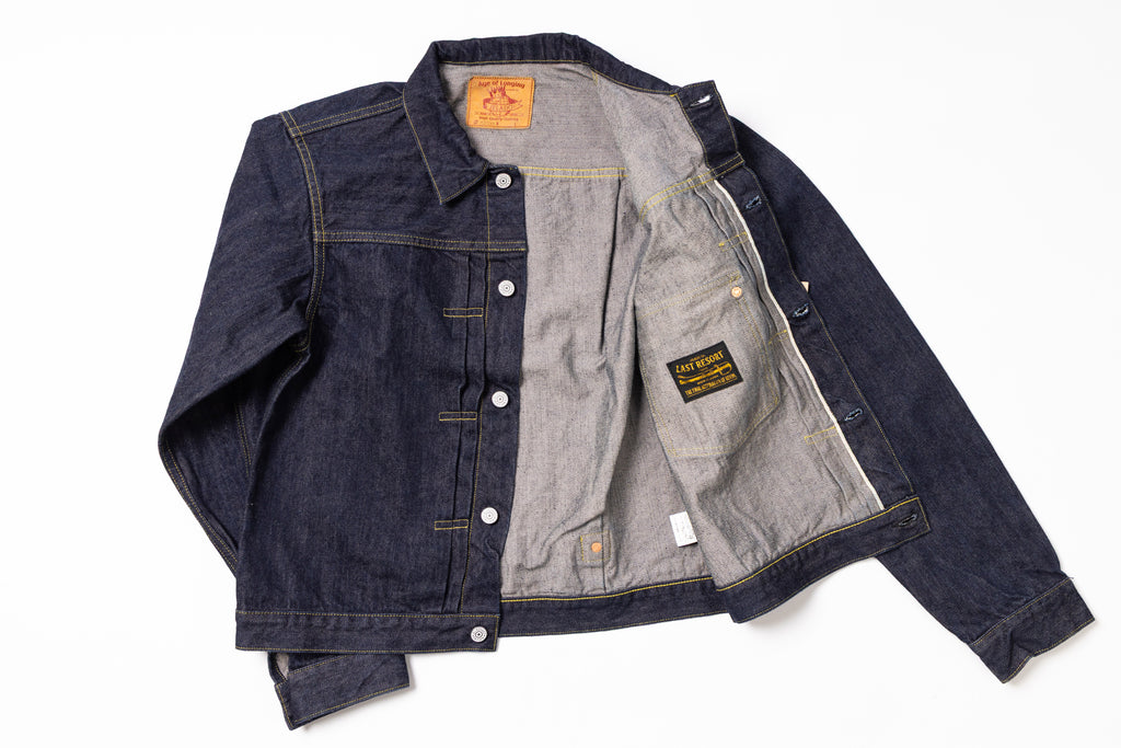 Denim jacket with brand label on a white background