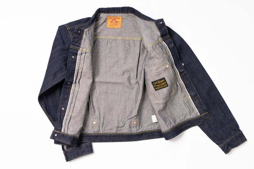 Denim jacket with brand label on a white background