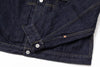Close-up of a dark blue denim jacket with buttons on a white background