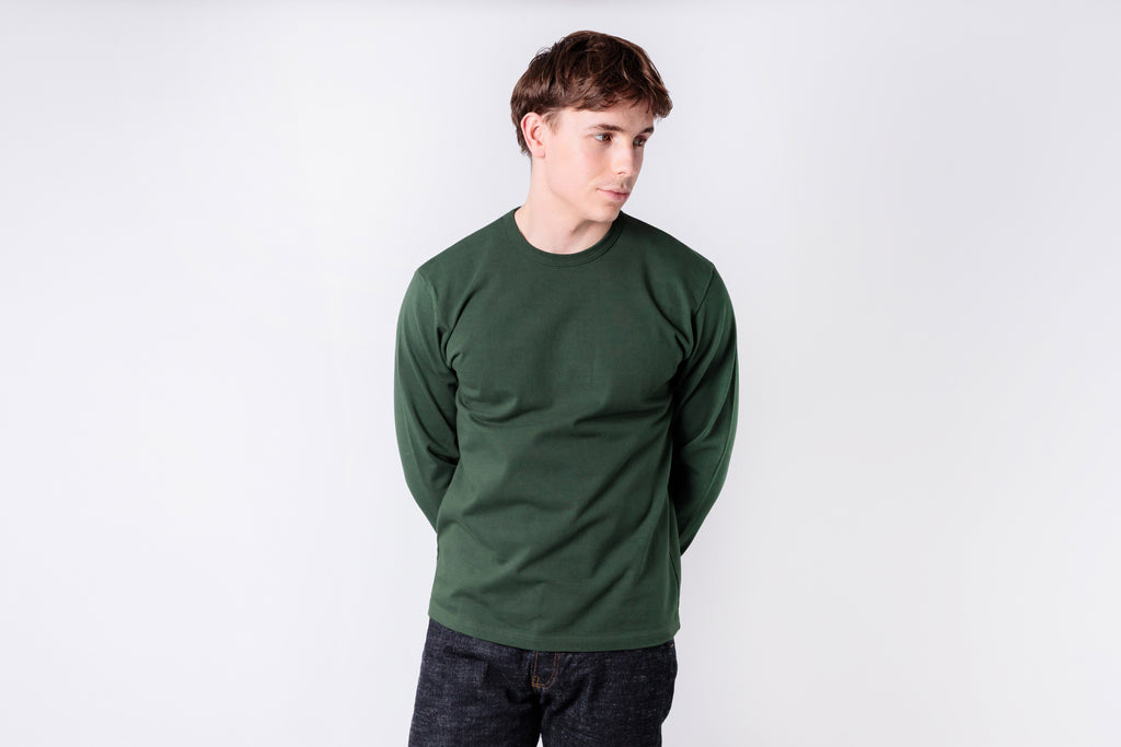 Person wearing a green sweatshirt on a white background