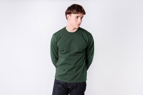 Person wearing a green sweatshirt on a white background