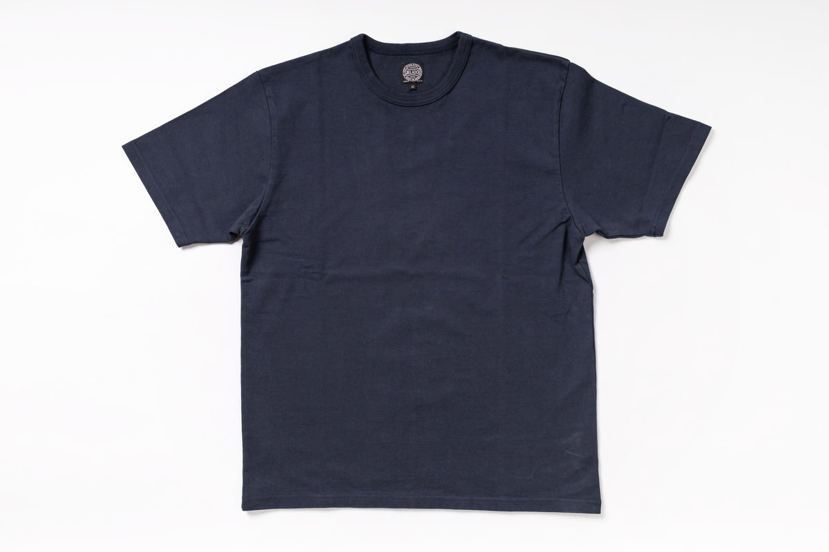 A dark navy blue short-sleeve crewneck t-shirt laid flat against a clean white background.