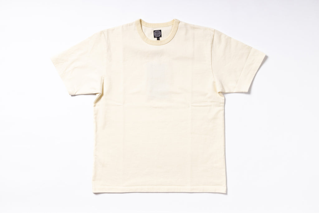 A cream-colored short-sleeve crewneck t-shirt laid flat against a clean white background.