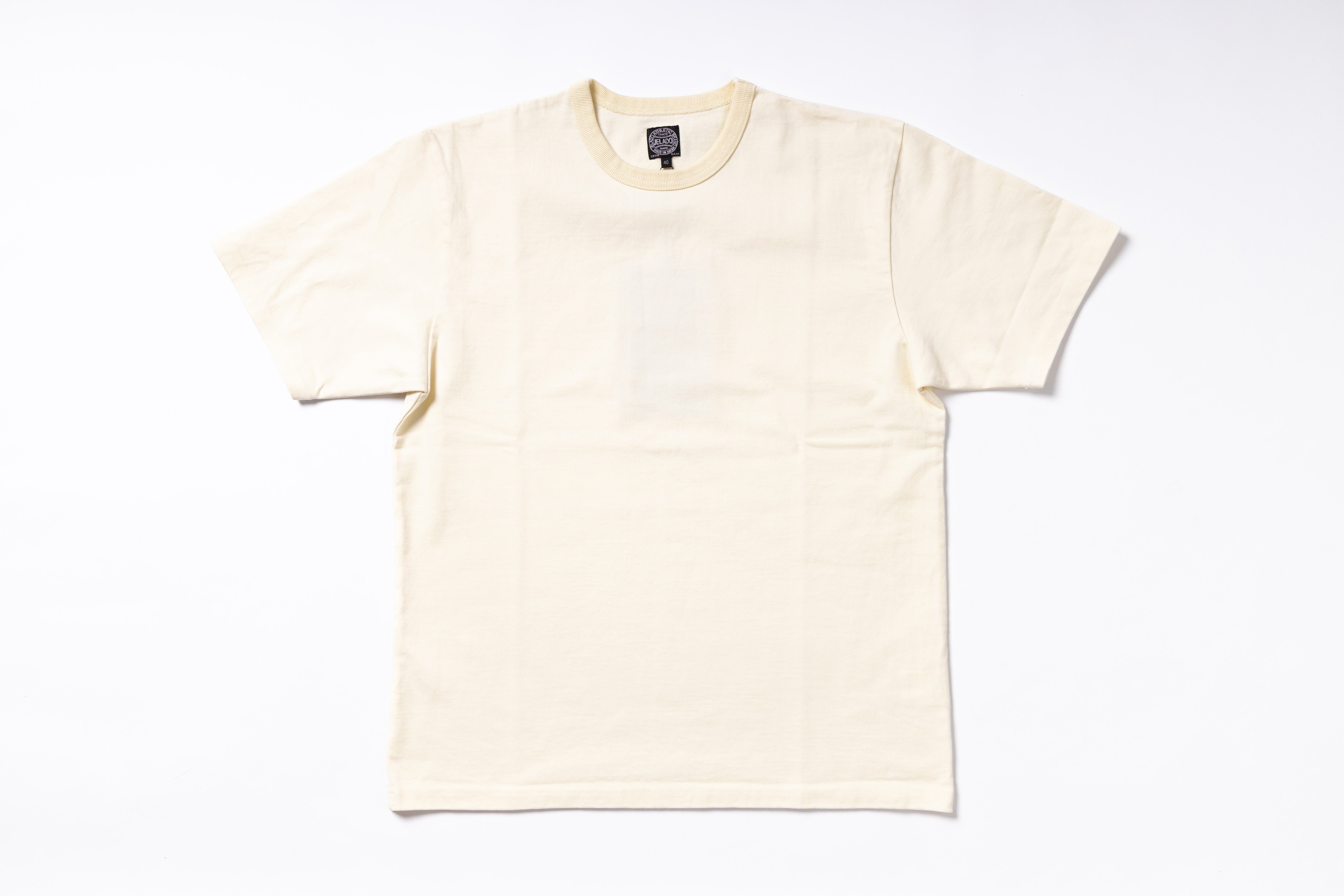 A cream-colored short-sleeve crewneck t-shirt laid flat against a clean white background.