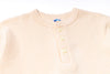 Beige textured shirt with buttons on a white background