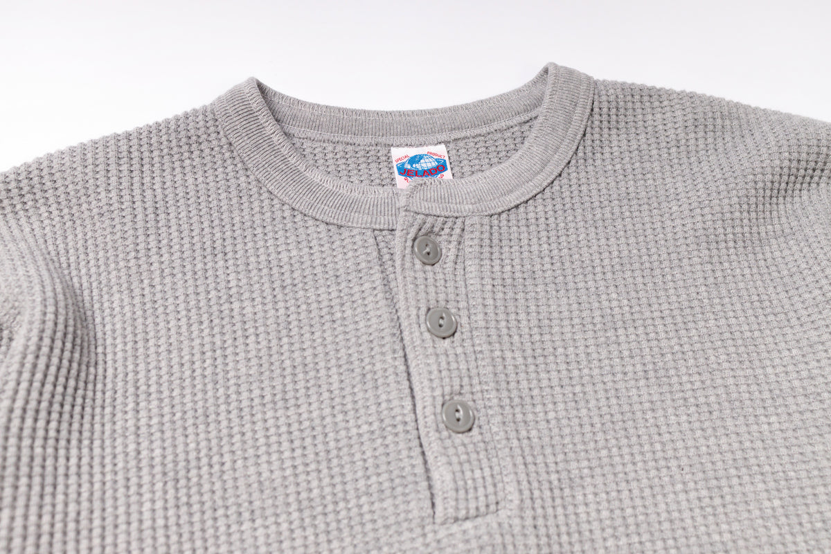 Gray waffle-textured henley shirt with buttons on a white background