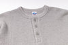 Gray waffle-textured henley shirt with buttons on a white background